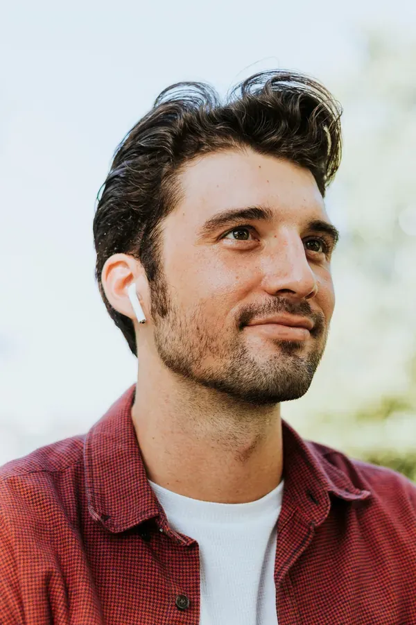 A futures trader in a red checked shirt, earbud in — Marco Renzi